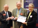 President Craigie presents Hudson Division Director Frank Fallon, N2FF, with his recently earned 160 Meter Worked All States award. Midwest Division Director Cliff Ahrens, K0CA, who provided Fallon with his final QSL, is at the left. Fallon retired from the Board following the meeting. [photo by Steve Ford, WB8IMY]